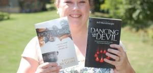 Kristine with a copy of Jeff's book & her own book.